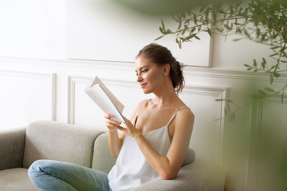 Woman reading a book in a minimal home