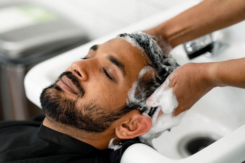Man getting a hair wash at a barber shop