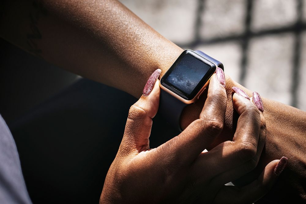 Woman checking time on smartwatch
