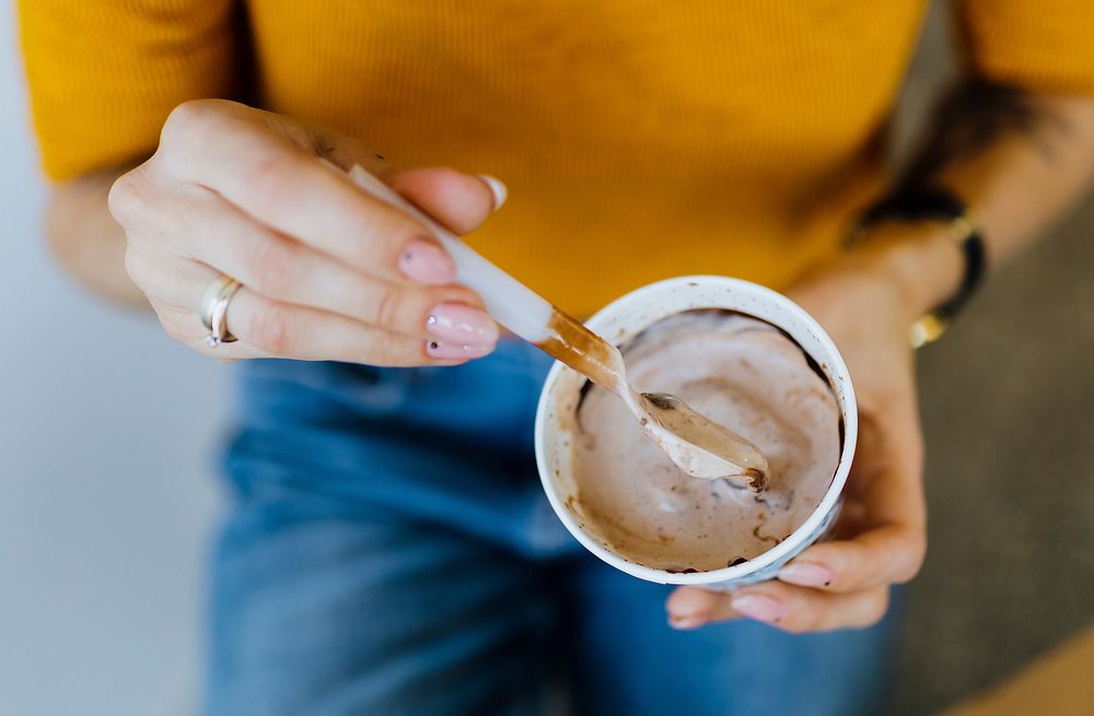 Closeup of woman eating a chocolate ice cream