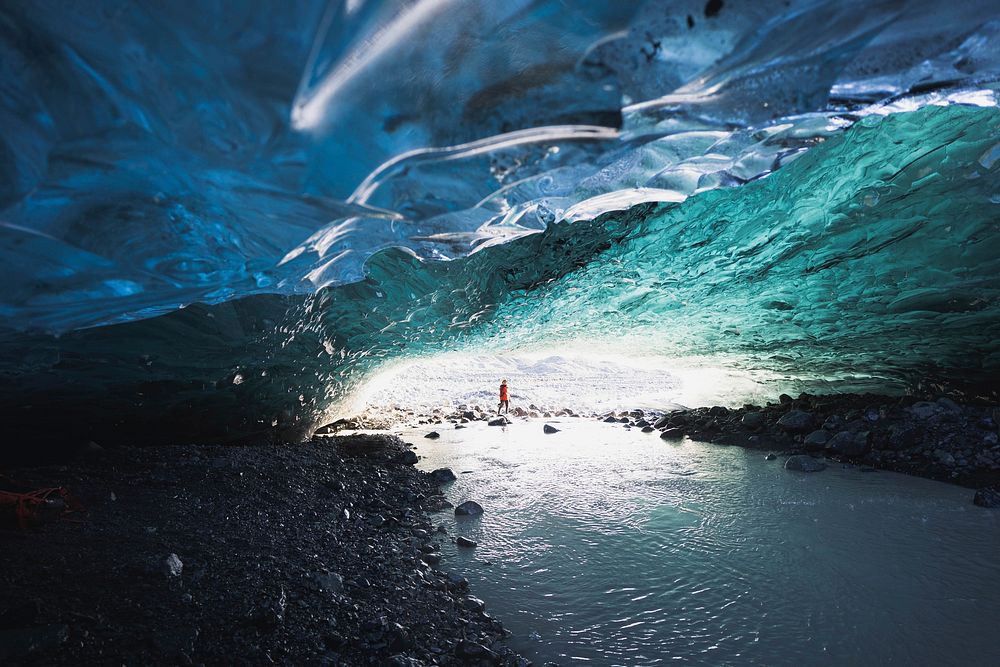Female explorer in the ice cave, Iceland