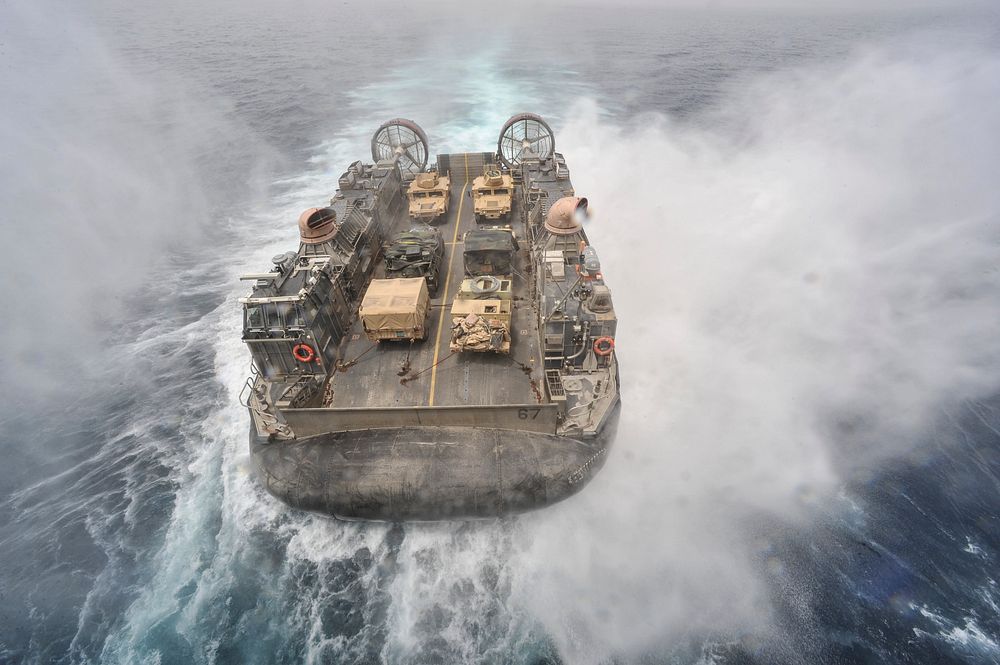 U.S. Navy Landing Craft, Air Cushion 67 approaches the well deck of the amphibious assault ship USS Bataan (LHD 5), not…