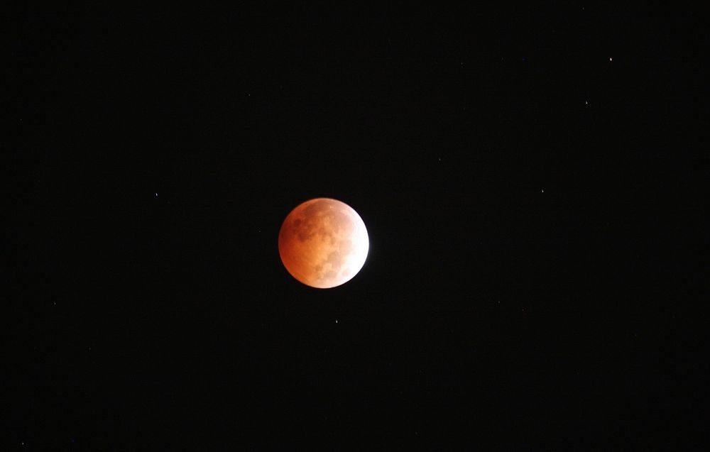 Lunar eclipse in night sky. Original public domain image from Flickr