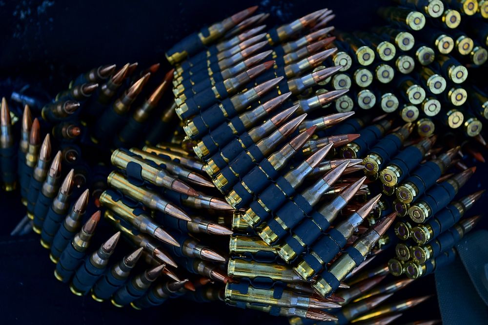 Linked 7.62 mm ammunition for M240B machine guns lays on the ground before paratroopers assigned the 4th Infantry Brigade…