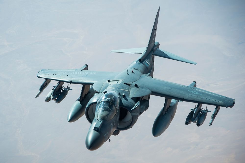 A U.S. Marine Corps AV-8B Harrier separates from a KC-10 Extender after receiving fuel during a mission in support of…