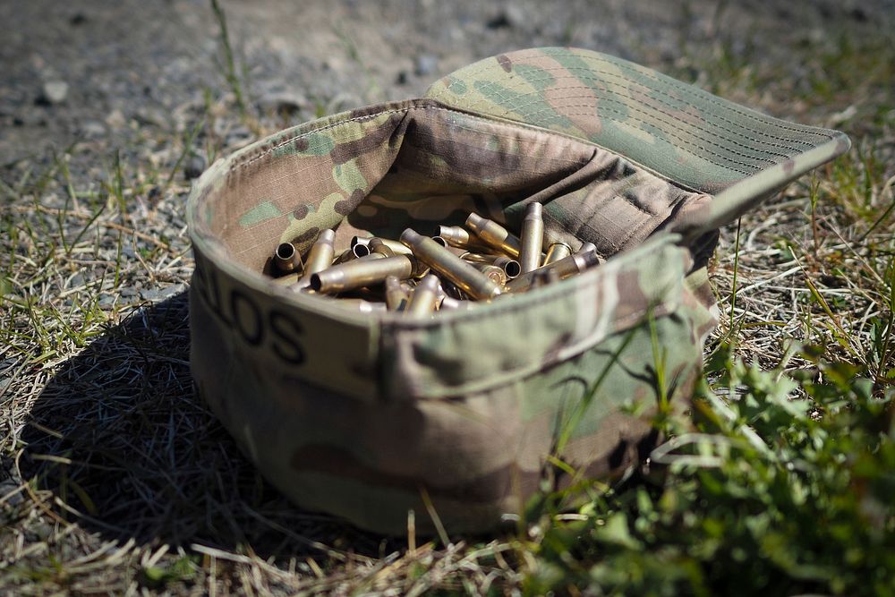 Expended casings are piled in a soldier’s cover as Soldiers assigned to the 98th Support Maintenance Company, 17th Combat…