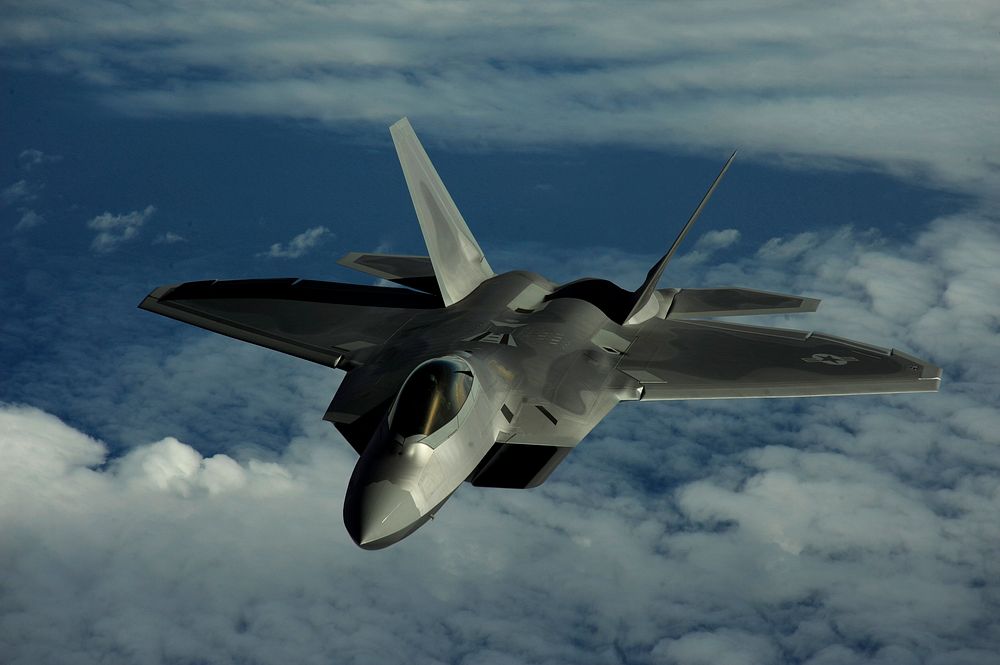 A U.S. Air Force F-22 Raptor aircraft assigned to the 90th Fighter Squadron out of Elmendorf Air Force Base, Alaska, flies…