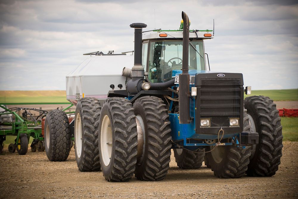 A tractor on the Auer Farm near Broadview, Mont., pulls a no-till drill. Yellowstone County, Montana. June 2017.. Original…