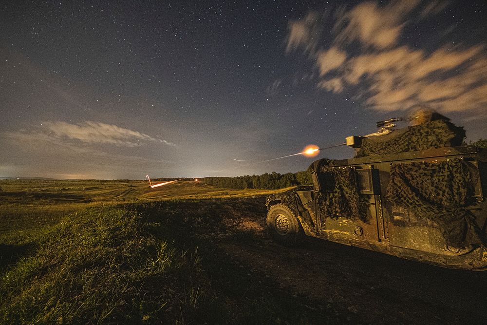 A U.S. Army Paratrooper assigned to 1st Battalion, 503rd Infantry Regiment, 173rd Airborne Brigade fires a .50 caliber…