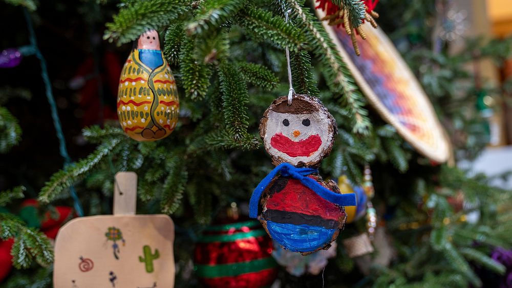 Christmas tree decorations made by New Mexico locals hang on the USDA Christmas Tree during the tree lighting ceremony, at…