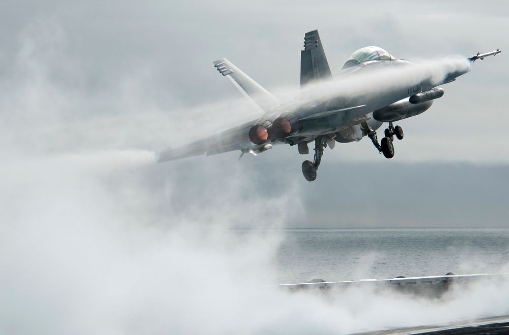 A U.S. Navy F/A-18F Super Hornet aircraft, with Strike Fighter Squadron 22 (VF-22), launches from the flight deck of the…