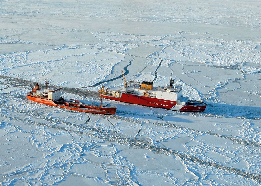 The USCG Healy (WAGB-20) breaks ice around the Russian-flagged tanker Renda 250 miles south of Nome, Alaska, Jan. 6, 2012.