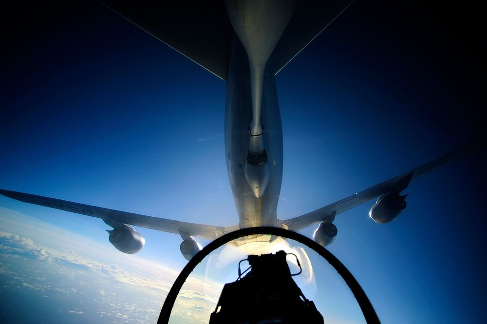 A U.S. Air Force KC-135 Stratotanker aircraft refuels an F-16 Fighting Falcon over the Pacific Ocean Feb. 16, 2012, during…
