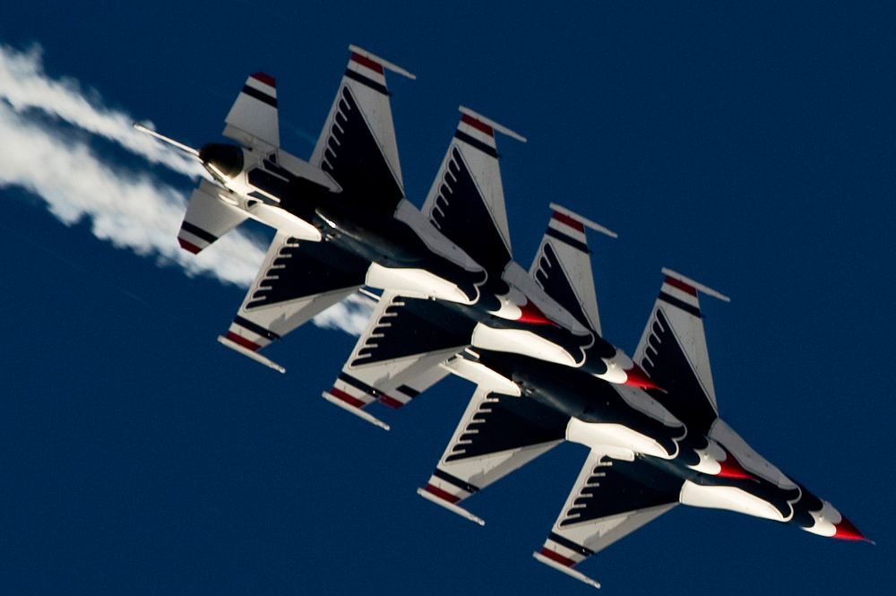 U.S. Air Force F-16 Fighting Falcon aircraft with the Thunderbirds demonstration team fly from the trail position into the…