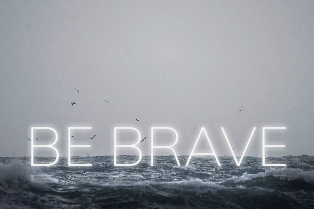 White neon text BE BRAVE typography