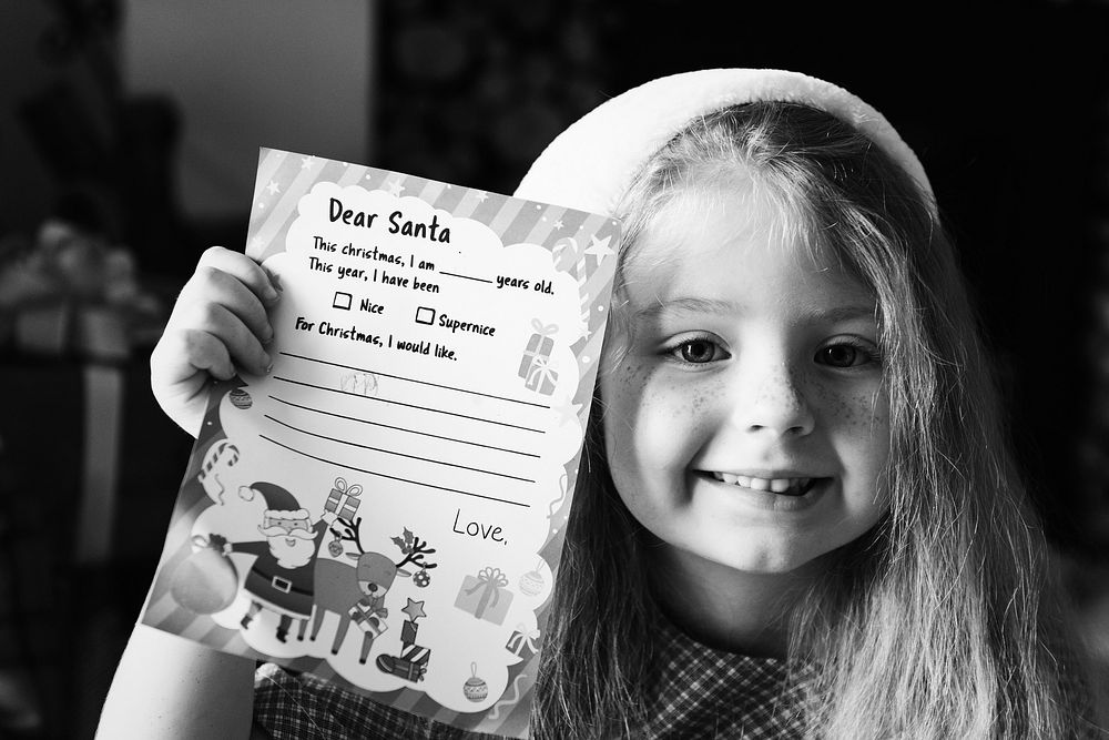 Little girl holding her Christmas wishlist