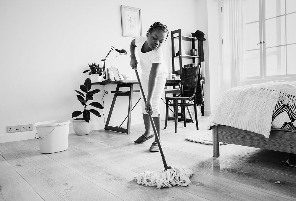 Young teen girl sweeping up from the floor