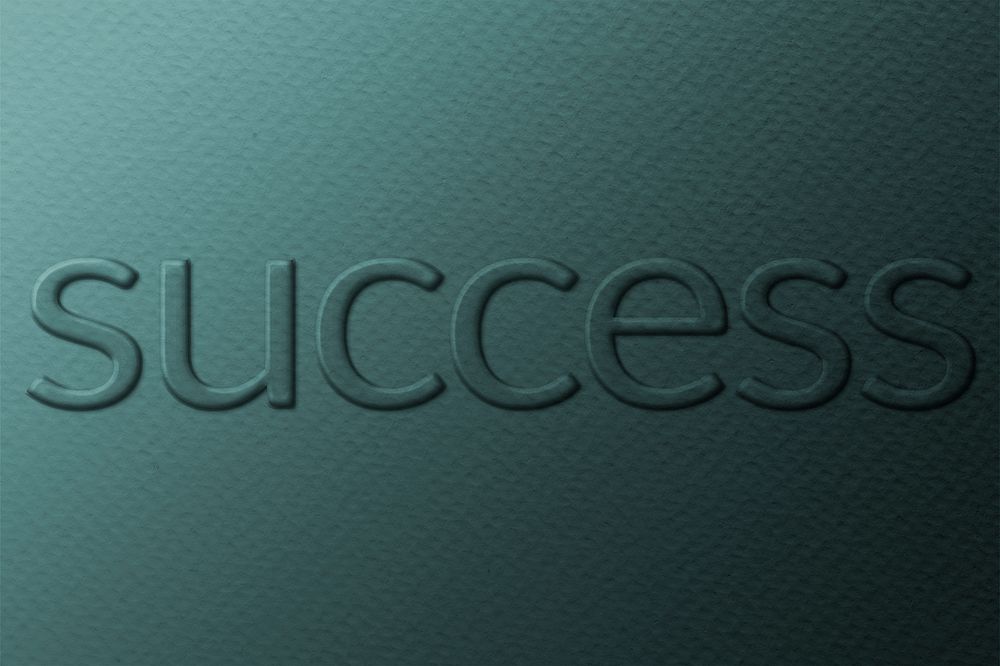 Word success embossed typography on paper texture