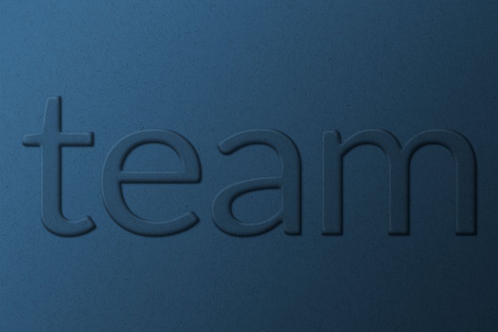 Word team embossed typography on paper texture