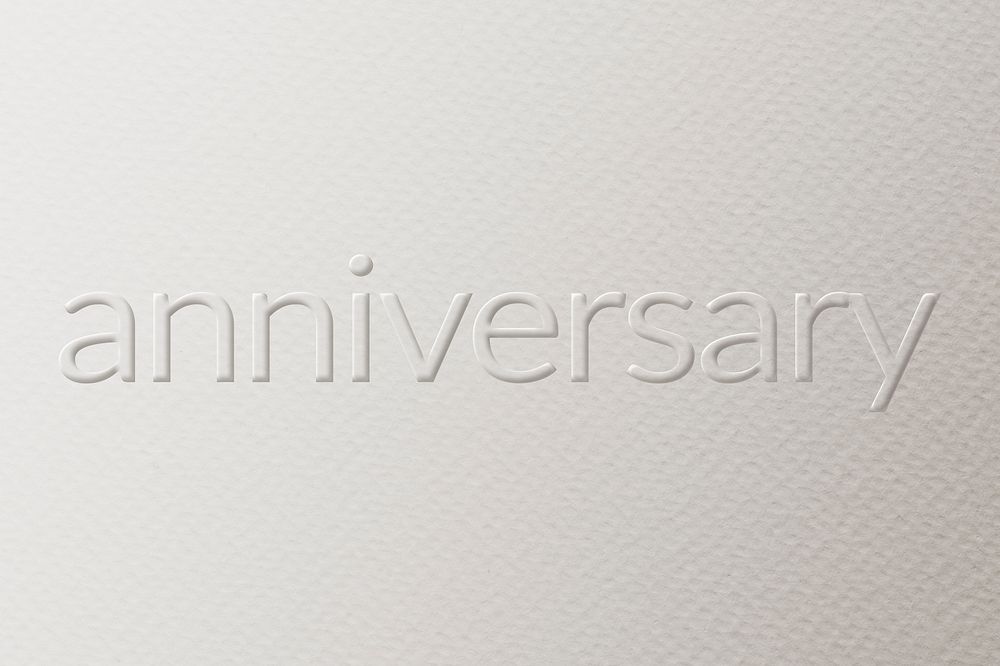 Anniversary embossed text white paper background