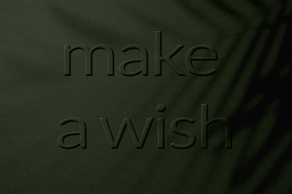Textured concrete background message embossed make a wish typography