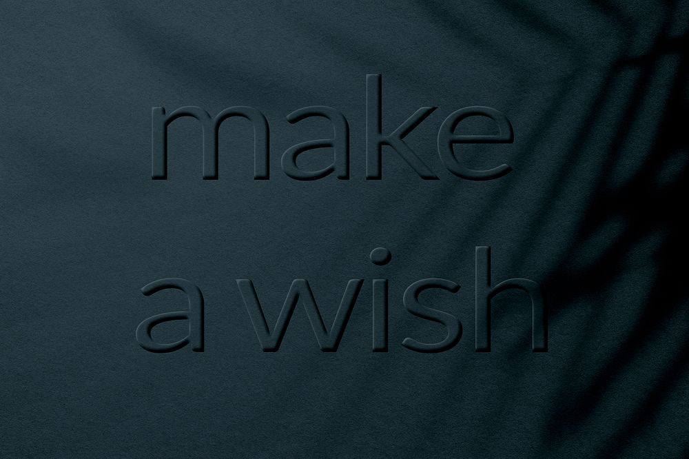 Textured blue concrete embossed make a wish message typography