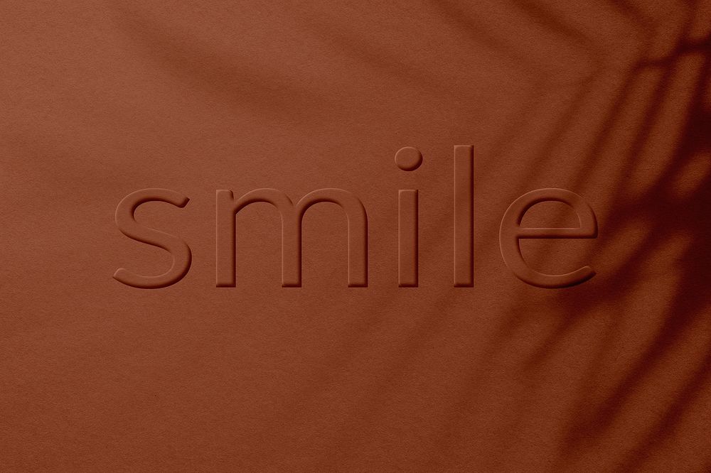 Embossed word smile concrete textured typography