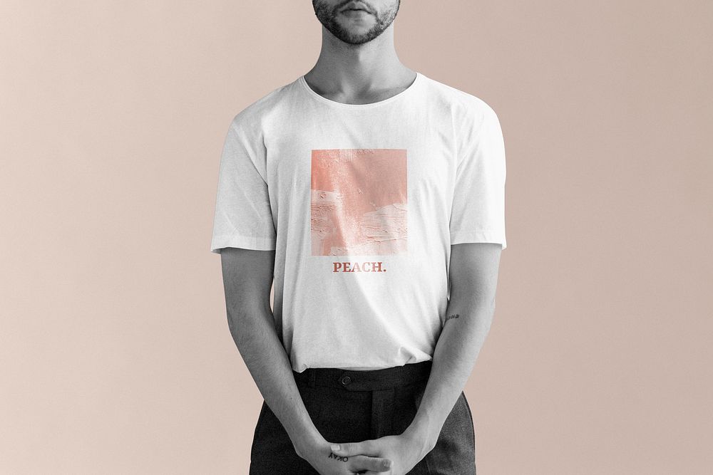 Man wearing t-shirt with minimal print in peach color