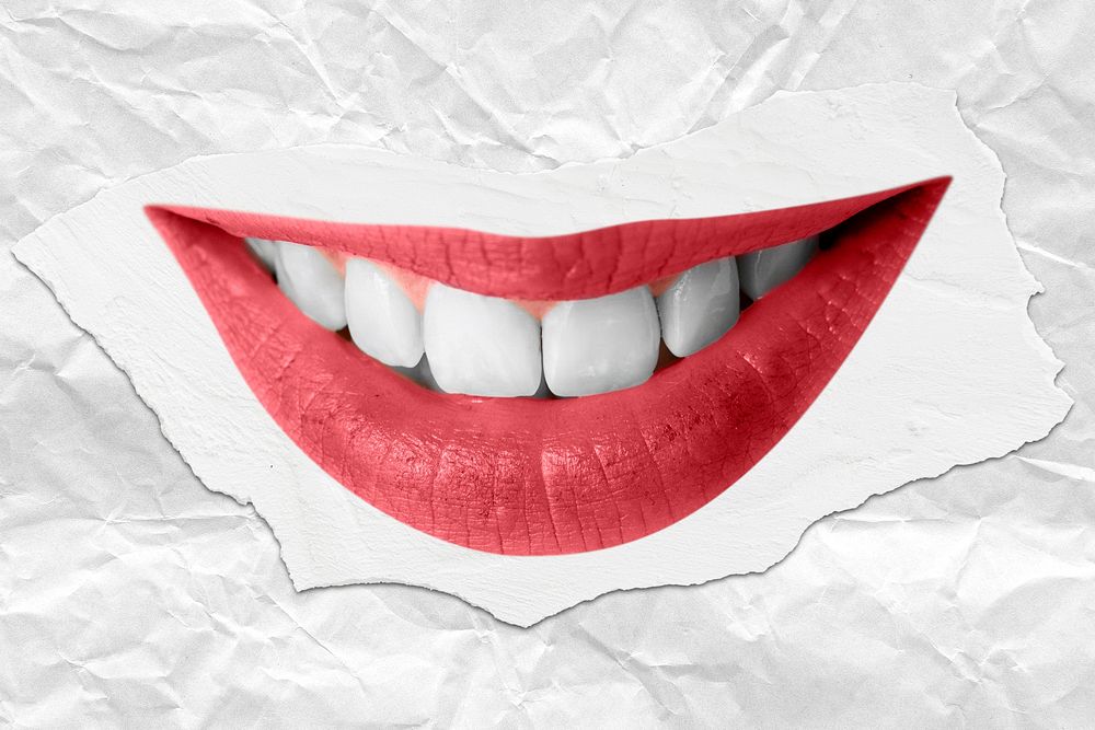 Smiling red lips with teeth closeup on ripped paper background