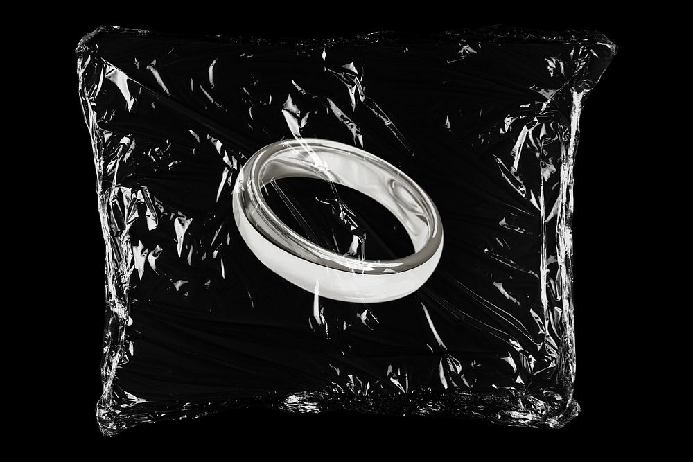 Silver wedding ring in plastic bag, marriage proposal creative concept art