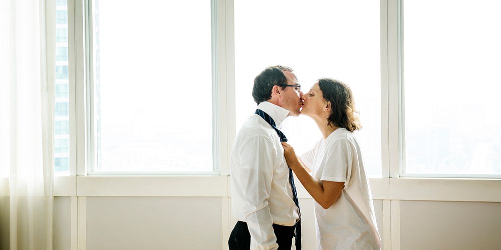 Woman kissing husband while dressing up social banner