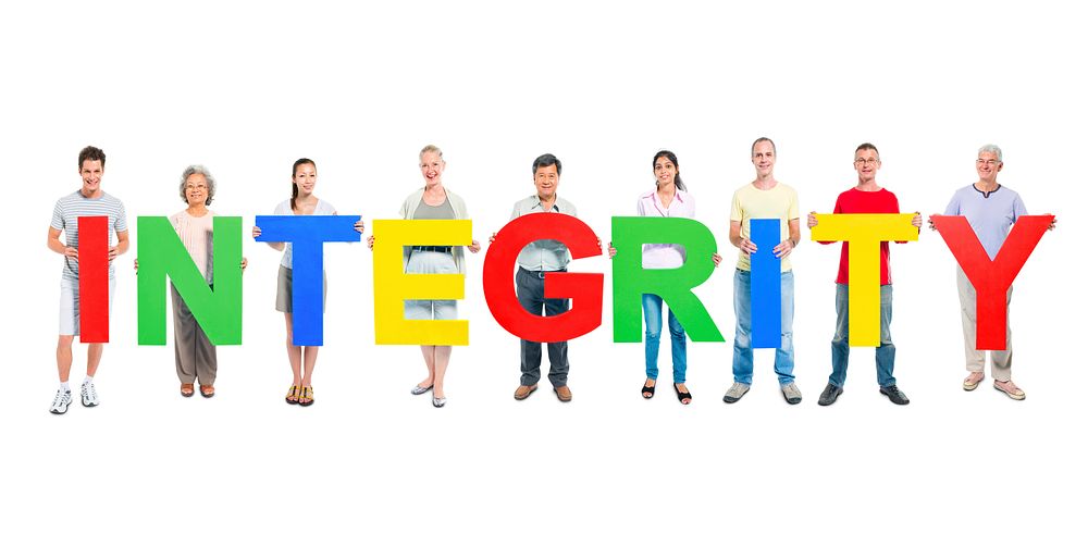 Multi-ethnic group of people holding "INTEGRITY" letters