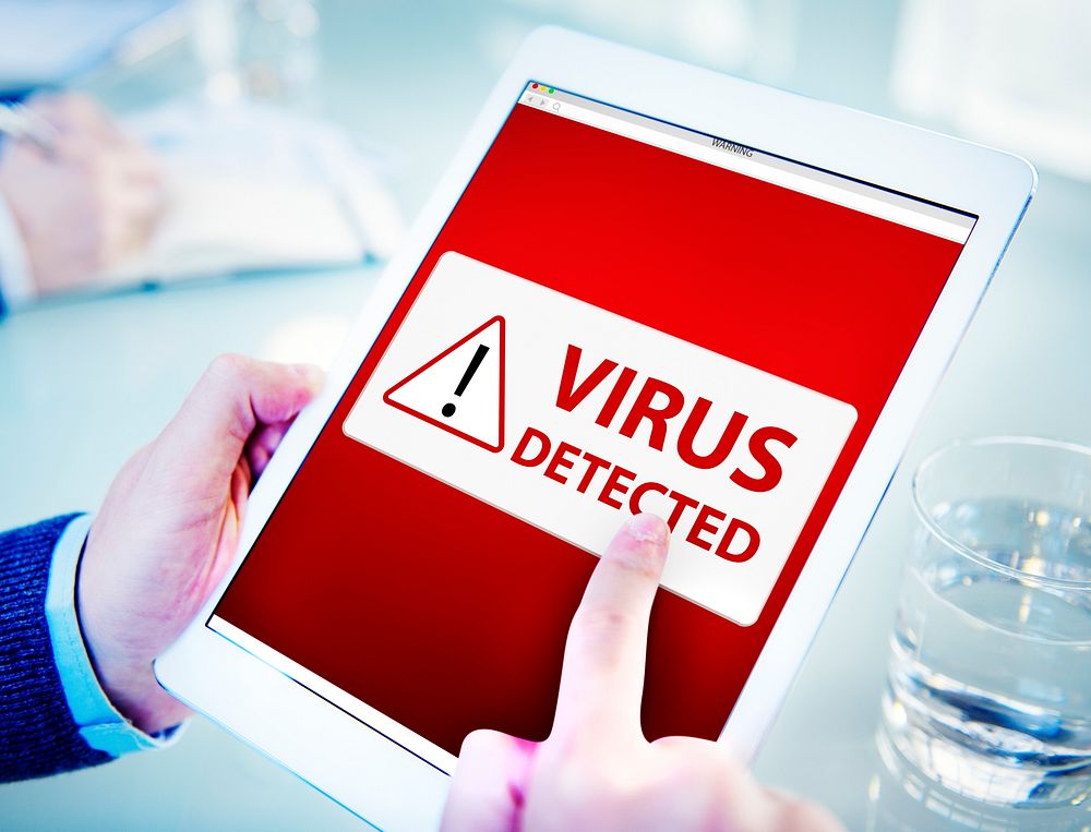 Man Using a Digital Tablet with Virus