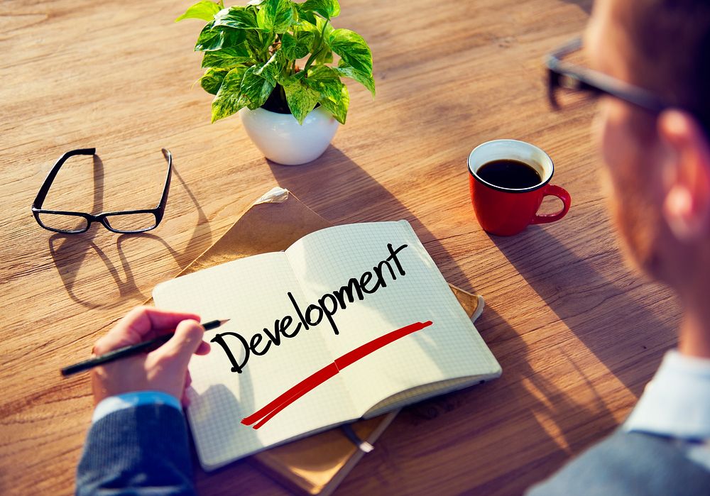 Businessman with Note About Development Concepts