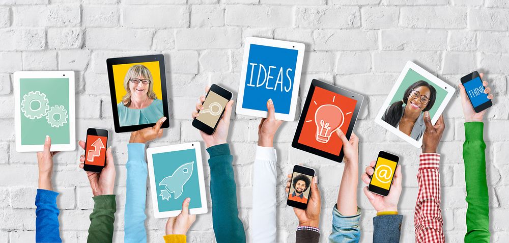 Group of Hands Holding Digital Devices with Ideas Concept