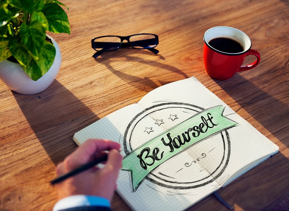 Businessman Writing the Words "Be Yourself"