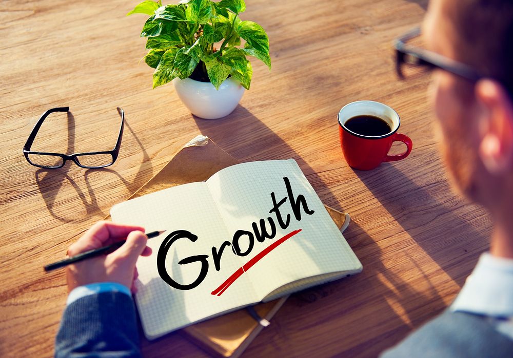 Businessman with Note About Growth Concepts