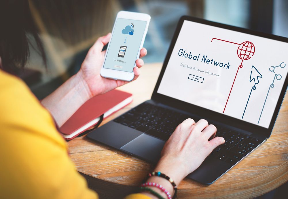 Woman connected with global communications network by laptop