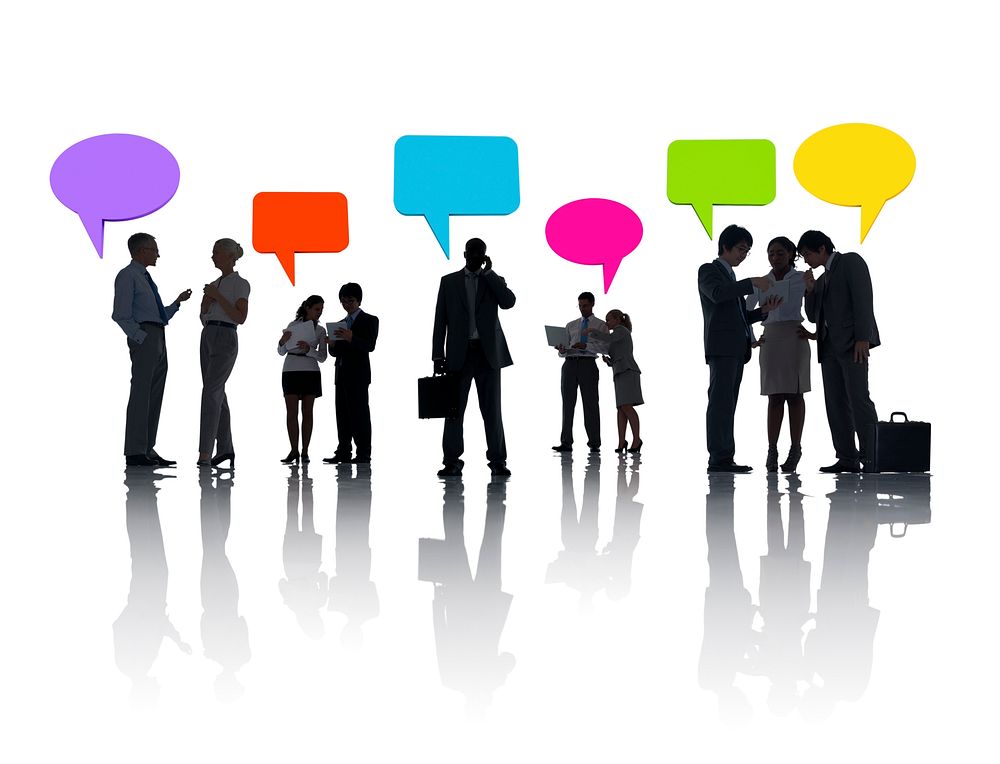 Business People Discussing And Multi-Colored Speech Bubbles Above Them.