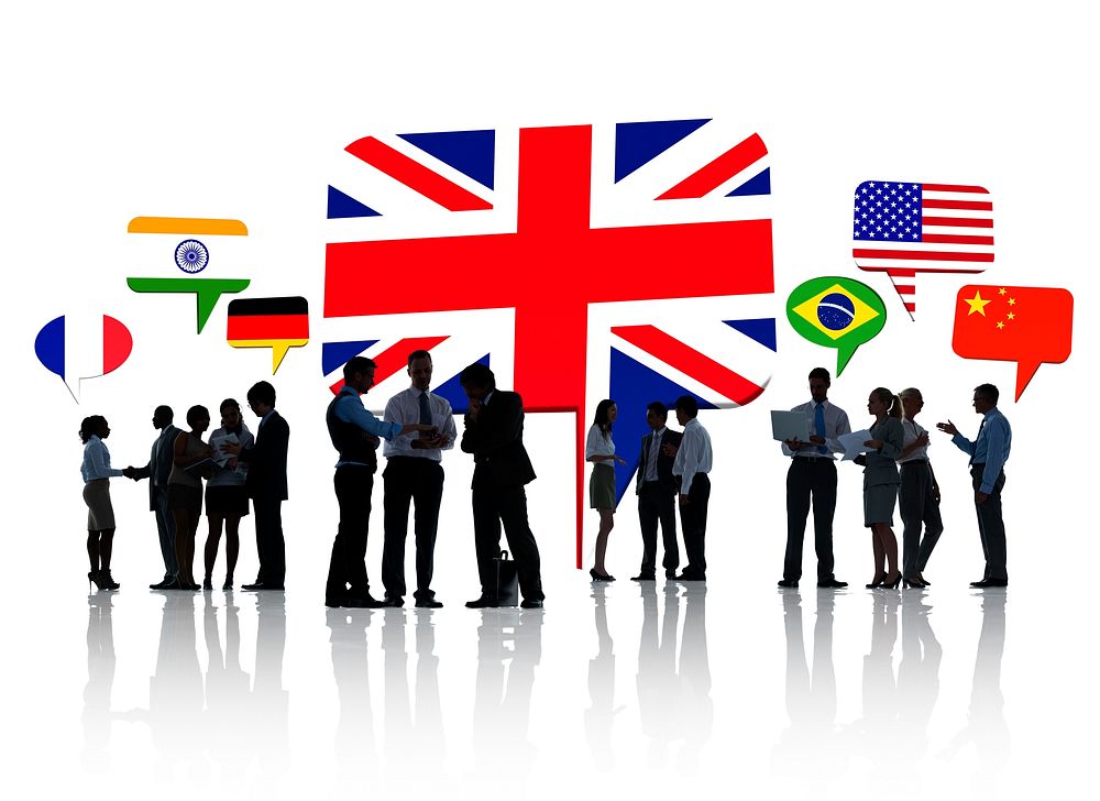 Silhouettes Of Business People Having A Discussion With Each Other And Speech Bubbles With Different National Flags Above…