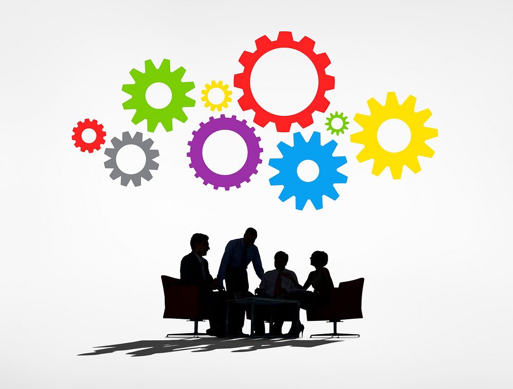 Silhouettes of Business People Having a Meeting and Gears Above