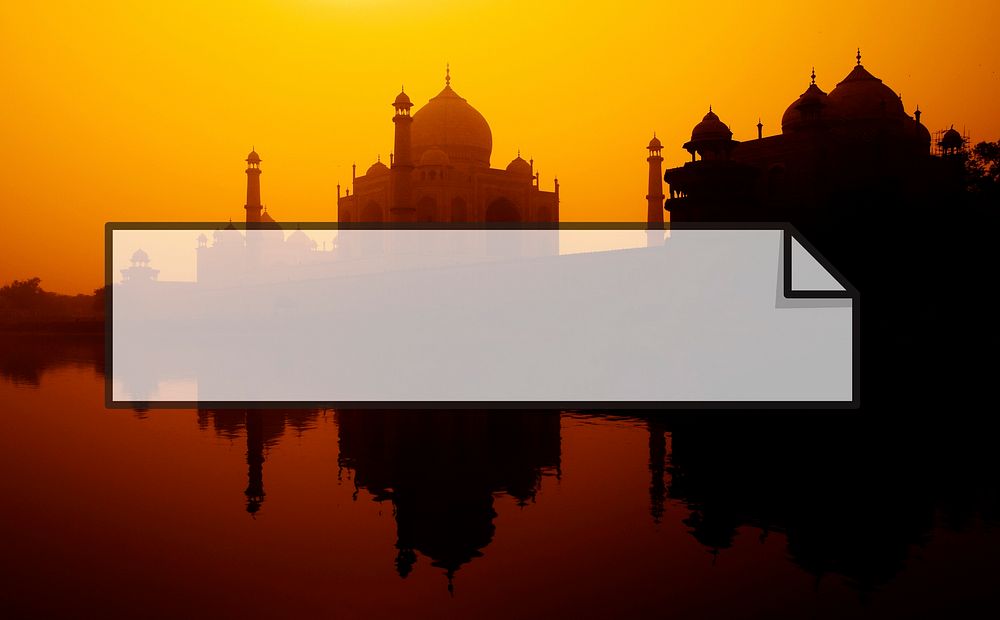 Sunset silhouette of a grand Taj Mahal.