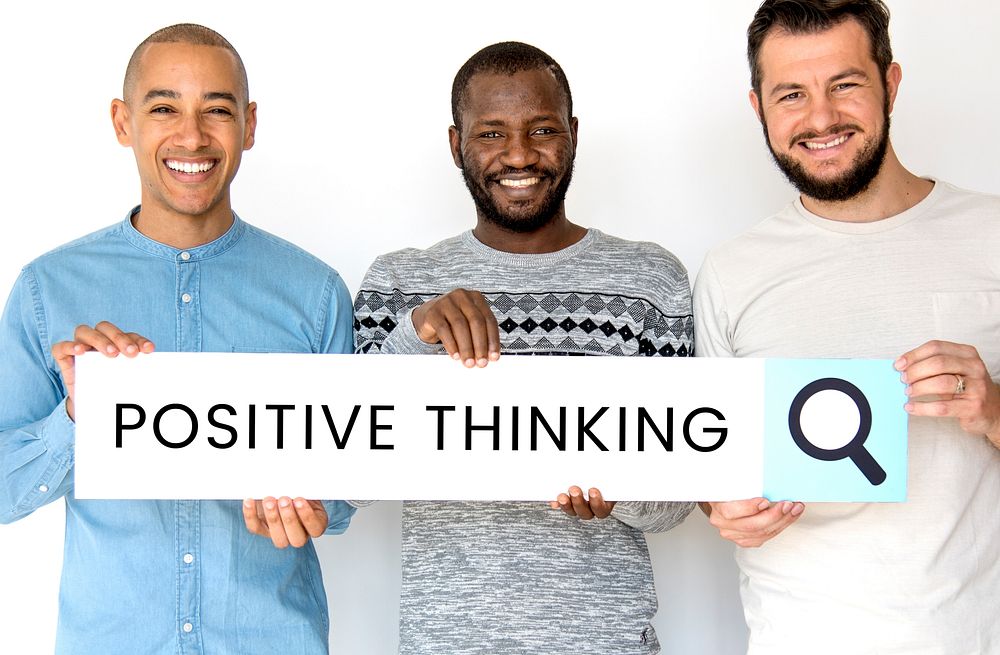People holding and showing the positive thinking word