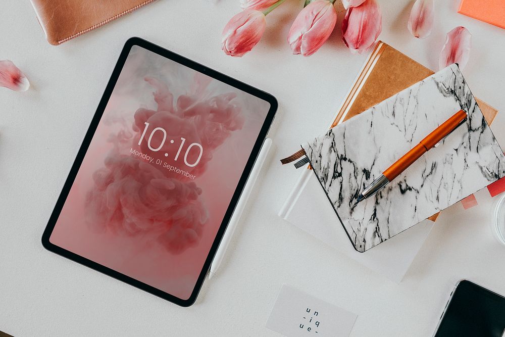 Digital tablet on a desk with flowers