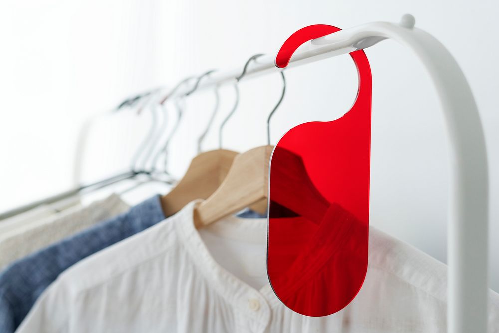 Shirt on a clothing rack with a red tag in a studio
