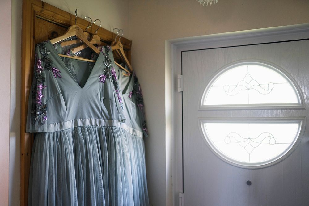 Bridesmaid dress hanging on wooden hangers