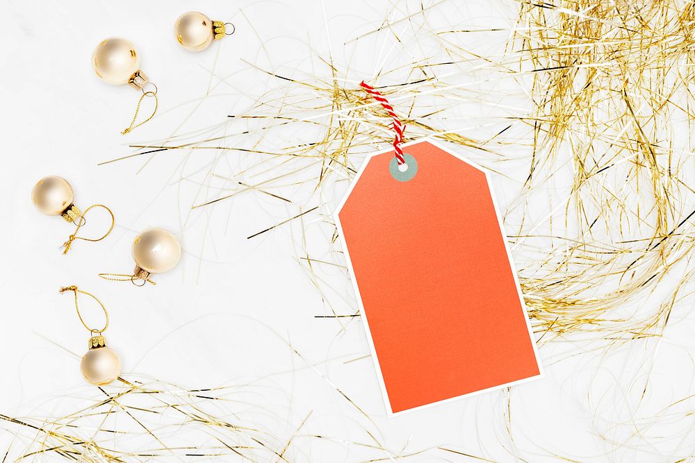 Orange tag with bauble and party streamer