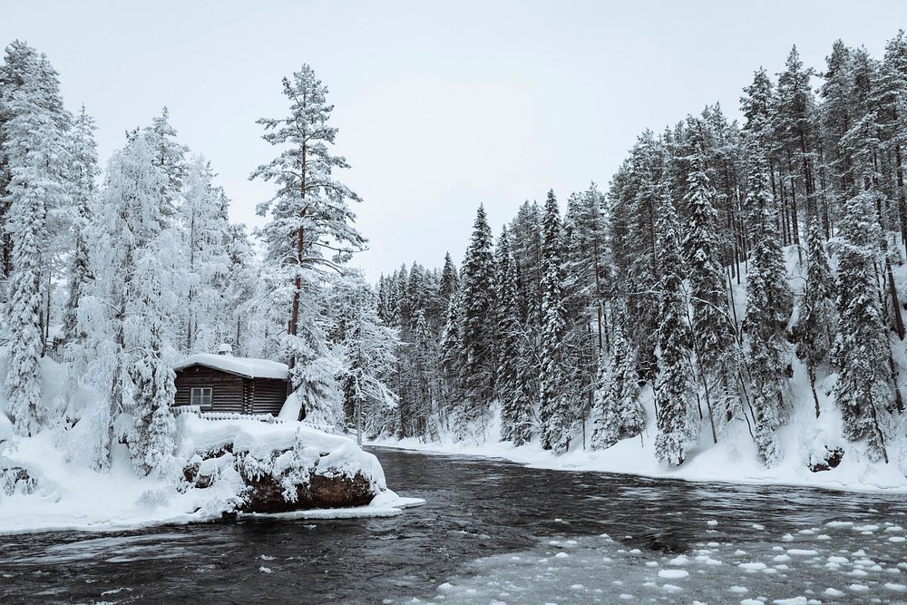Snow-covered hut by  river in the Oulanka National Park, Finland