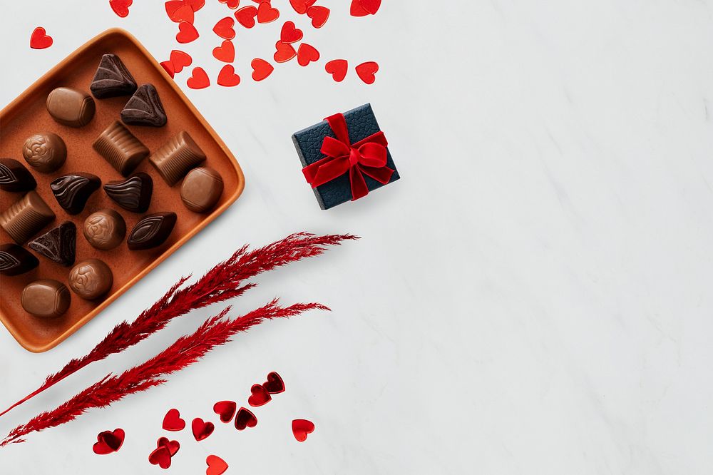 Chocolates on a tray by paper hearts