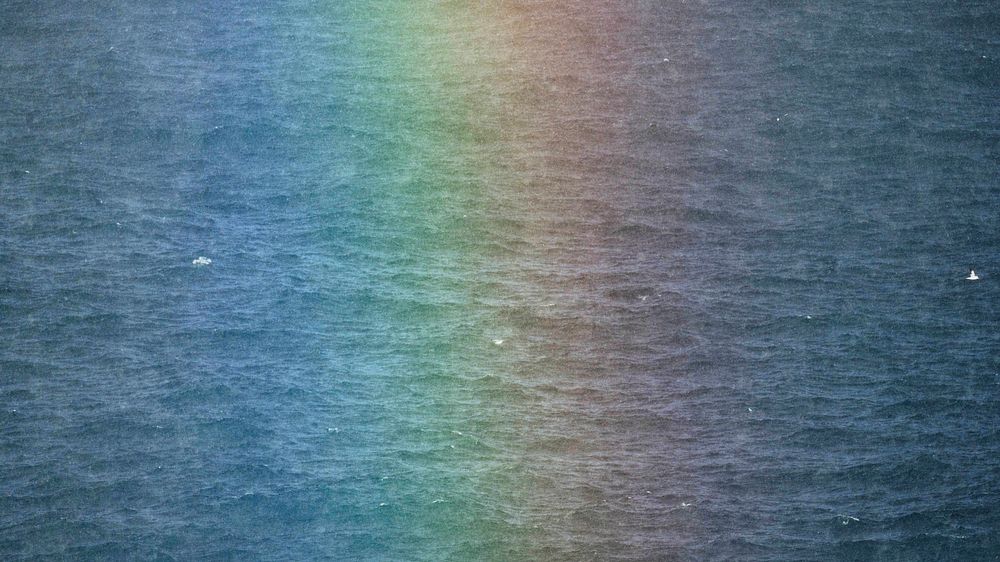 Rainbow after the rain over the Atlantic ocean in the Faroe Islands